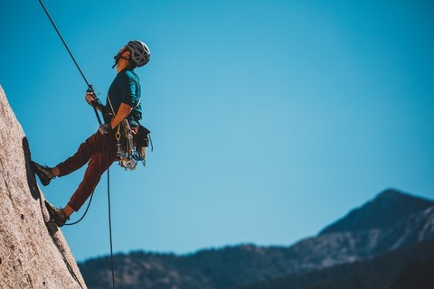 a man scaling a mountain